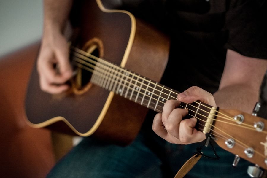 Artist playing acoustic guitar